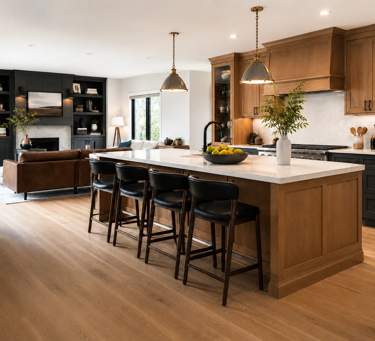 Warm wood kitchen with a large island, black stools, and a connected family room